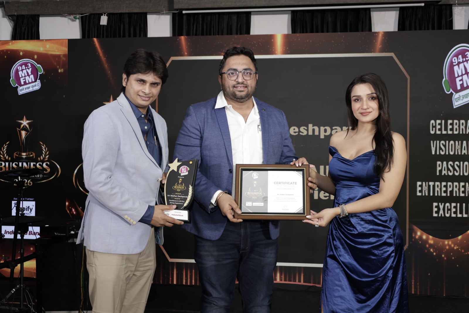 Seven O' Eleven's founders receiving the 94.3 MY FM Business Excellence Award 2026
