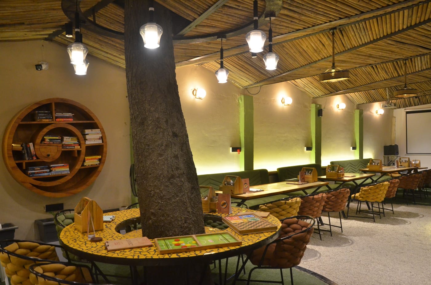 Bamboo ceiling, live tree trunk and circular book shelf