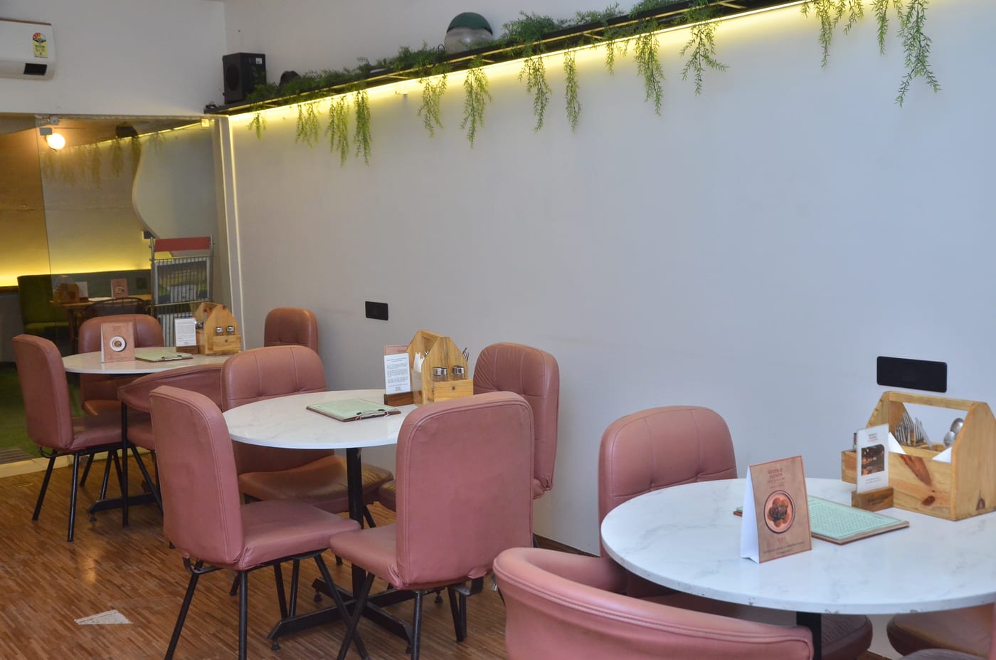 Seven O' Eleven indoor dining — blush velvet chairs and marble tables